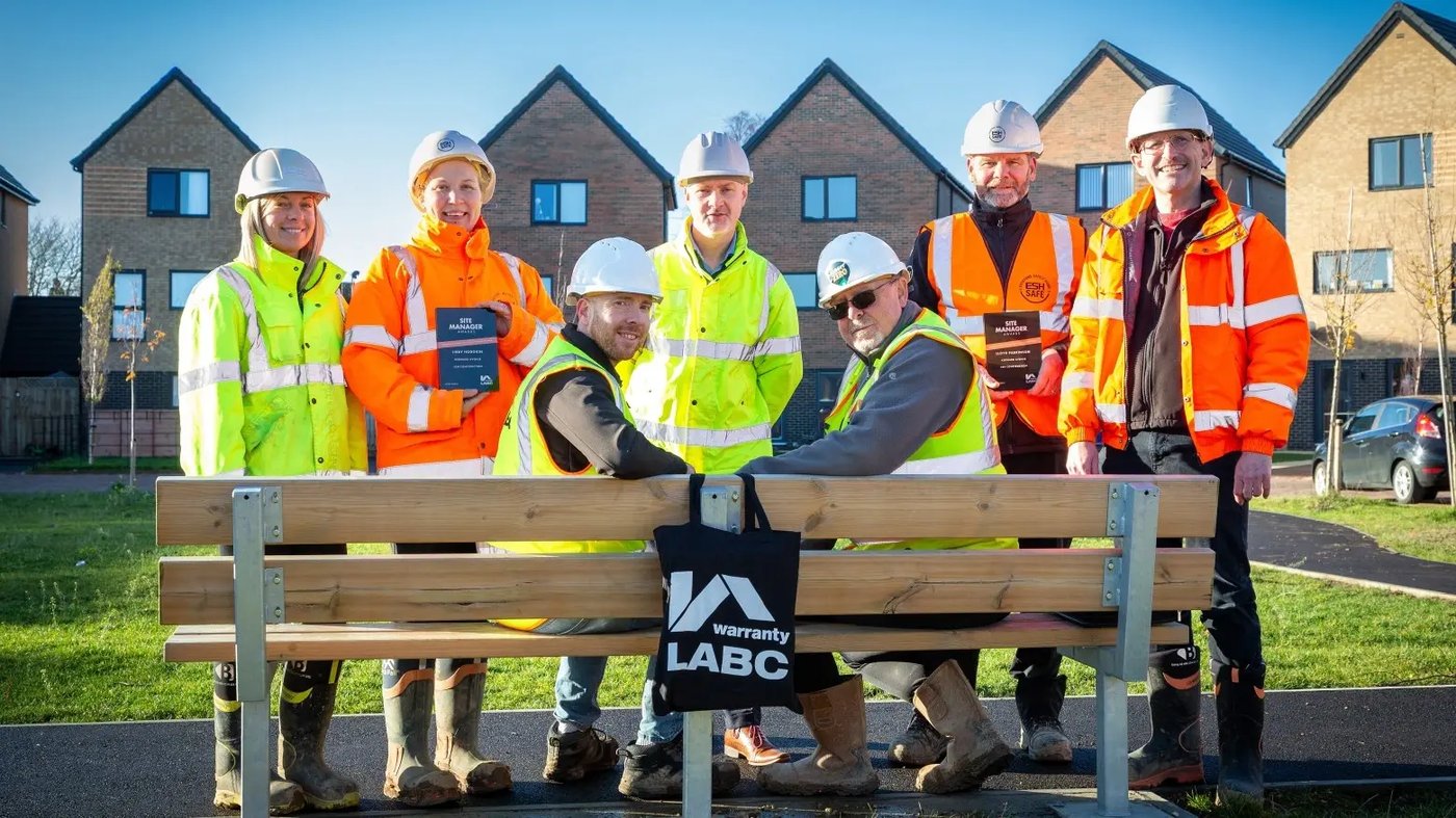 Libby Hodgkin and Lloyd Parkinson, Site Managers at Kedward Avenue, showing off their Site Manager Awards with some of the site team.