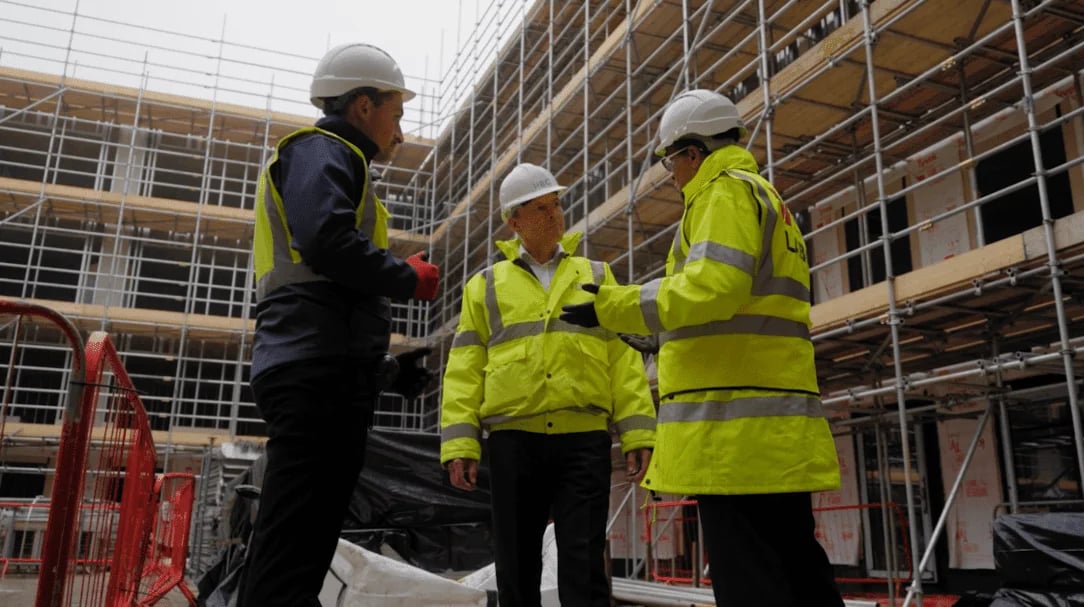 Inland Homes trio on roof with scaff