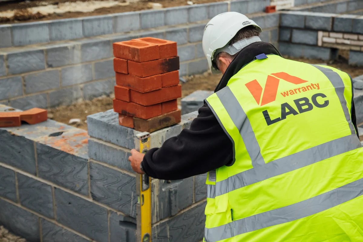 LABC Warranty surveyor checking level of wall