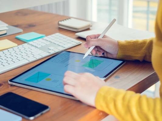 designer-woman-drawing-a-website-outline-and-website-ux-app-on-picture-id1207537604
