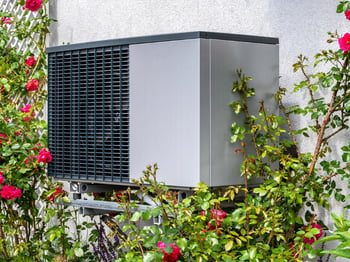 outdoor-unit-of-heat-pump-heating-of-residential-house-framed-by-picture-id1402870992